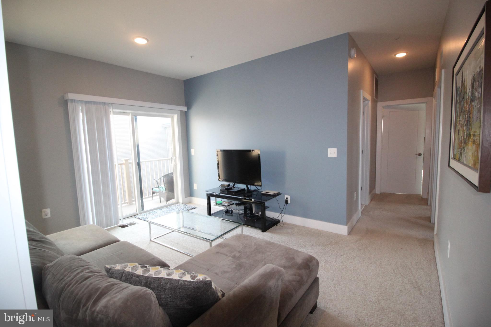 44738 Tiverton Square Ashburn, VA 20147 - Photo 32 of 66 a bedroom with a bed and a flat screen tv