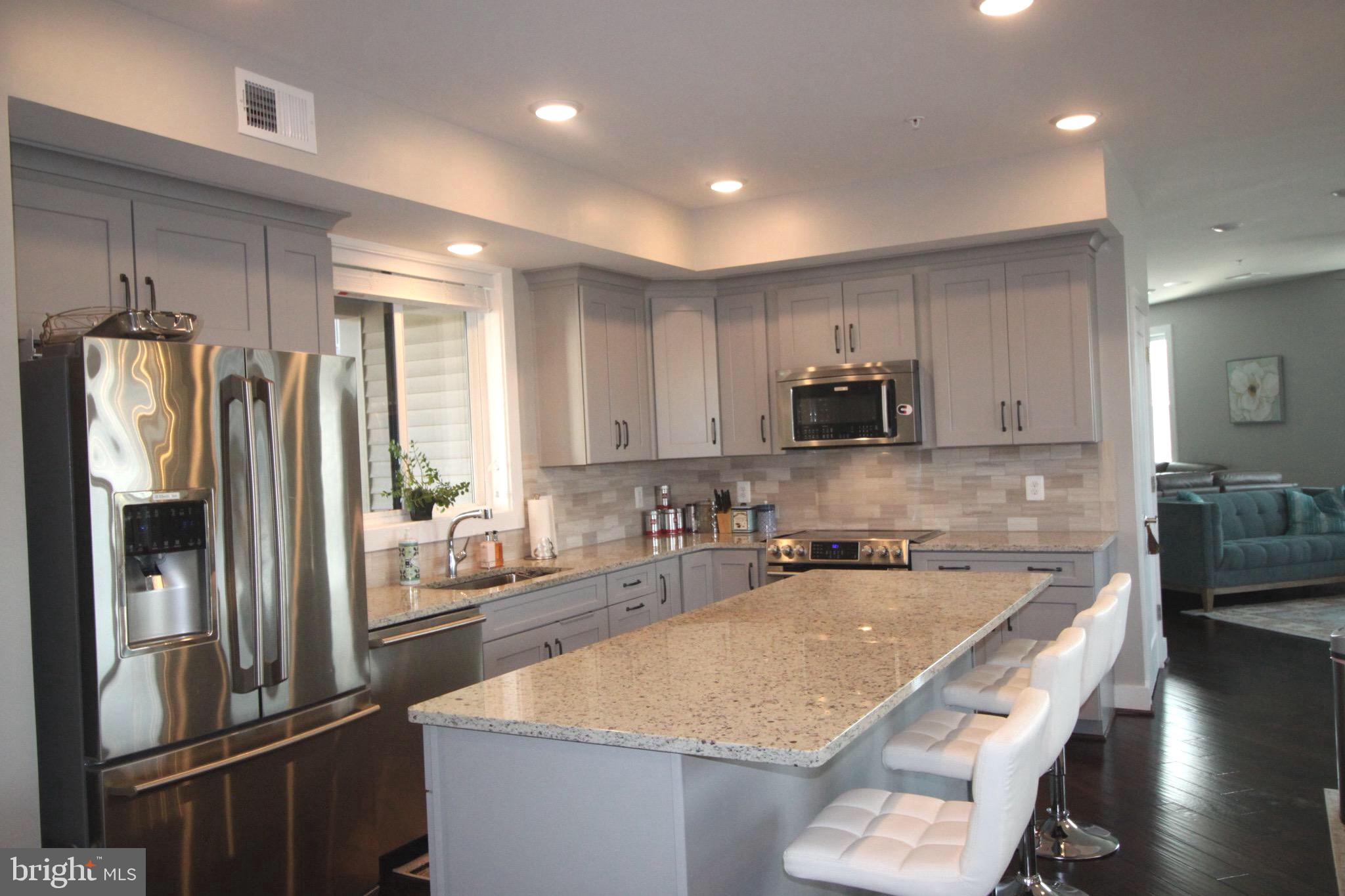 44738 Tiverton Square Ashburn, VA 20147 - Photo 4 of 66 a kitchen with stainless steel appliances granite countertop a refrigerator and a sink