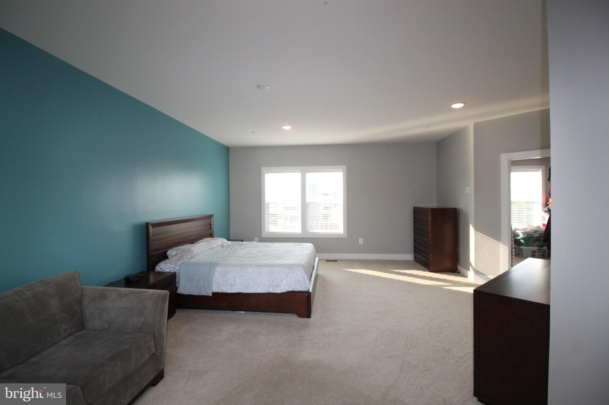 44738 Tiverton Square Ashburn, VA 20147 - Photo 42 of 66 a spacious bedroom with a bed and window