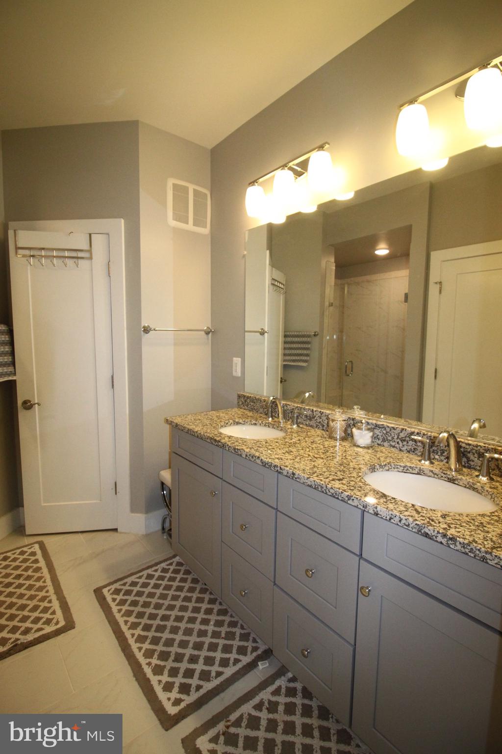44738 Tiverton Square Ashburn, VA 20147 - Photo 50 of 66 a bathroom with a granite countertop sink and a mirror