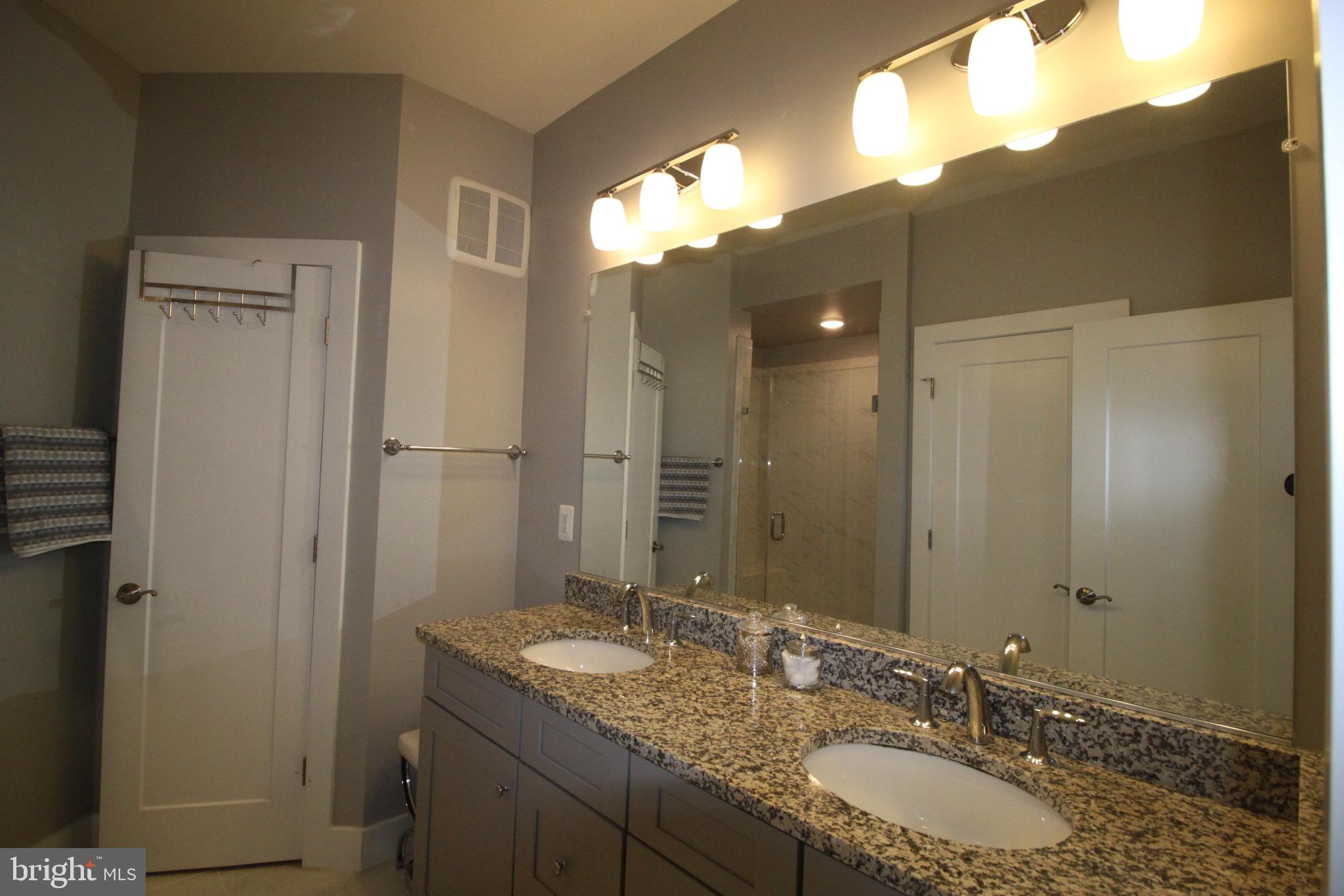 44738 Tiverton Square Ashburn, VA 20147 - Photo 51 of 66 a bathroom with a granite countertop sink and a mirror