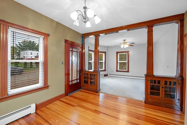 a view of a livingroom with furniture window and wooden floor