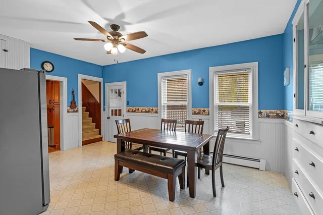 a dining room with furniture and window