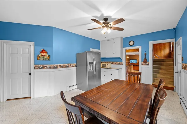 a room with stainless steel appliances kitchen island a table and chairs in it
