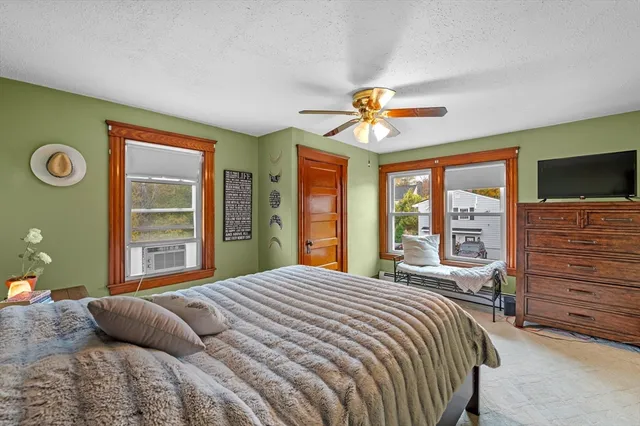 a bedroom with a large bed and a window