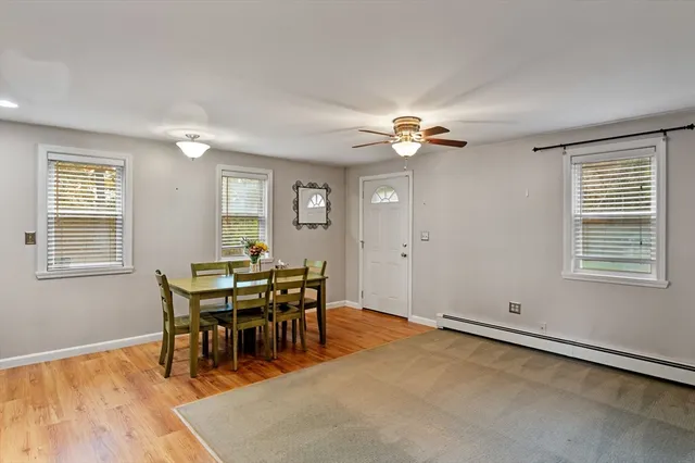 a view of a dining room with furniture and chandelier