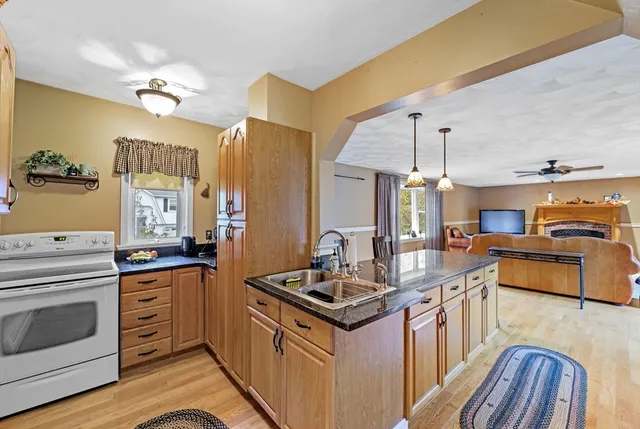 a kitchen with granite countertop a stove oven and sink