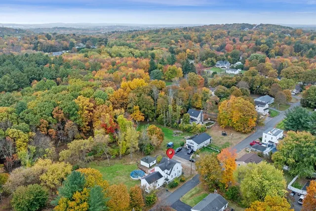 an aerial view of a residential houses with outdoor space