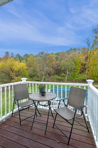 a balcony with table and chairs