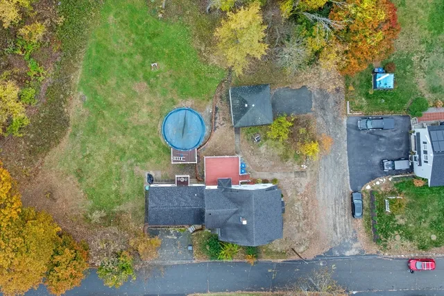 an aerial view of a house with garden space and street view