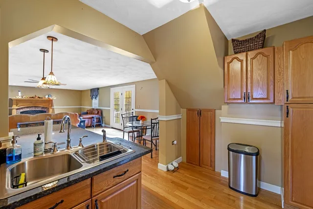 a kitchen with stainless steel appliances granite countertop a sink refrigerator and cabinets