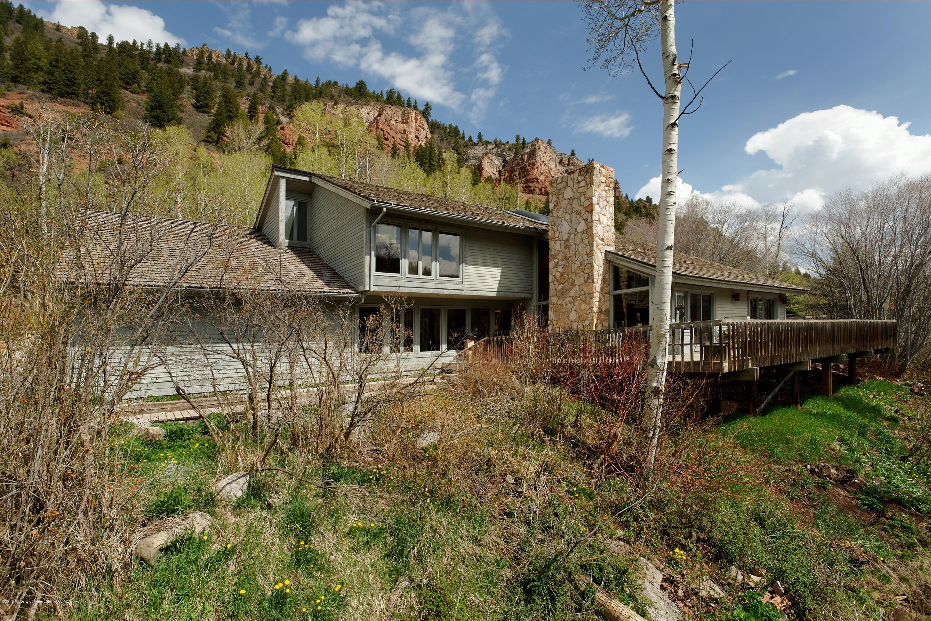 2021 Maroon Creek Road Aspen, CO 81611 - Photo 19 of 21 a view of a house with a yard