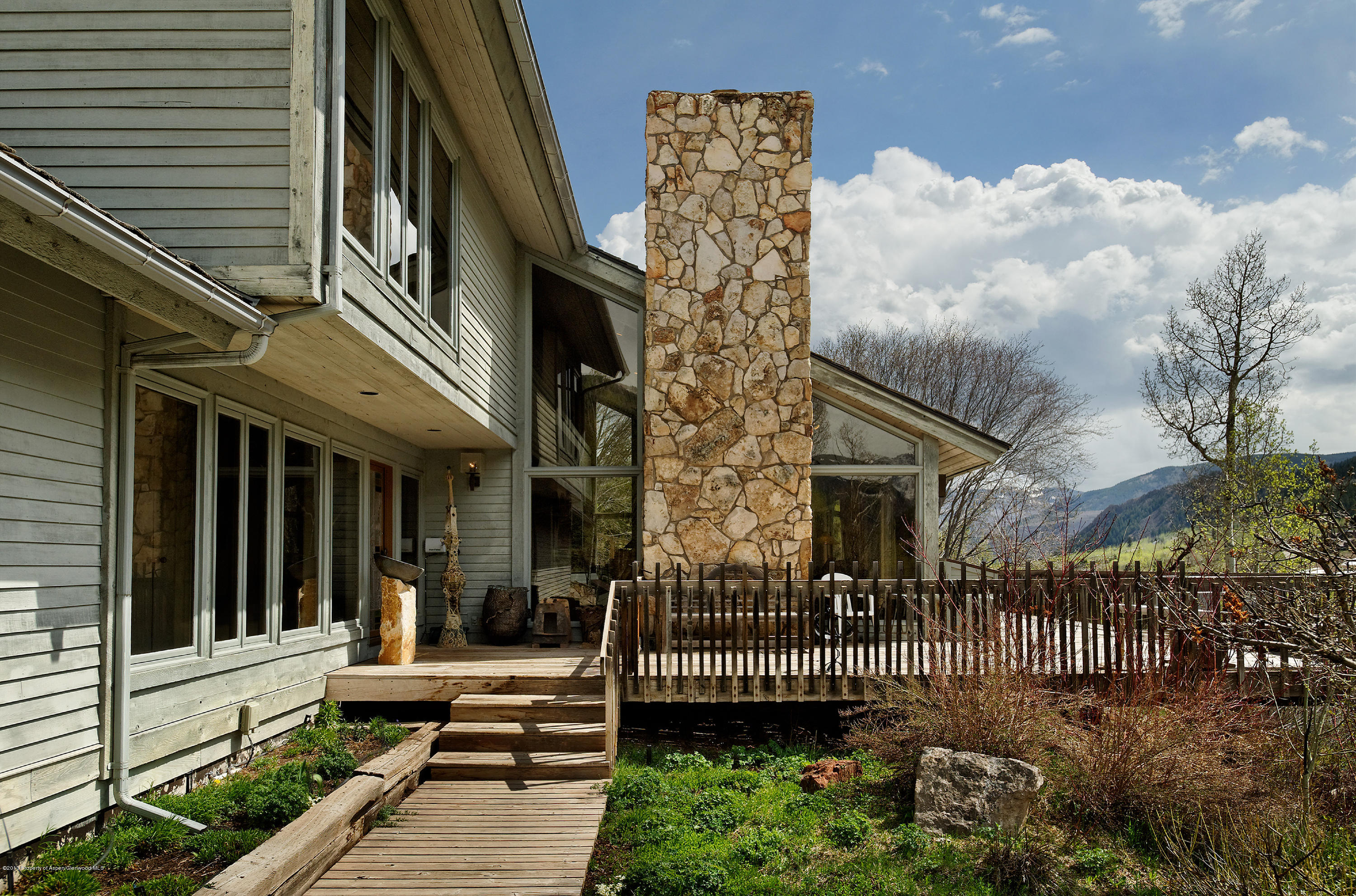 2021 Maroon Creek Road Aspen, CO 81611 - Photo 2 of 21 a front view of a house with a garden