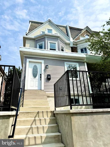 a view of entryway and kitchen with wooden floor