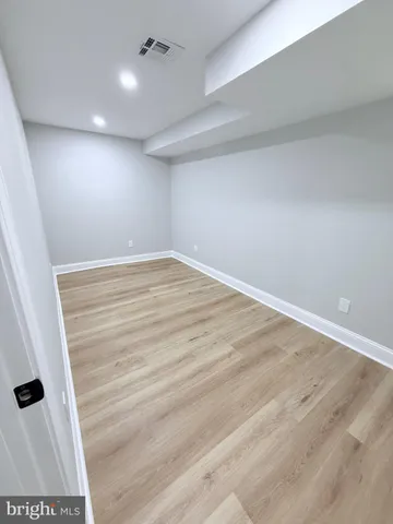 a view of a kitchen with granite countertop a stove top oven a sink and dishwasher with wooden floor