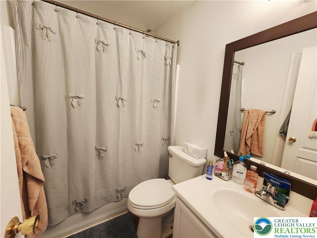 237 Ridings Circle Macungie, PA 18062 - Photo 45 of 70 A classic vanity mirror pairs with clean white surfaces in this functional bathroom layout.