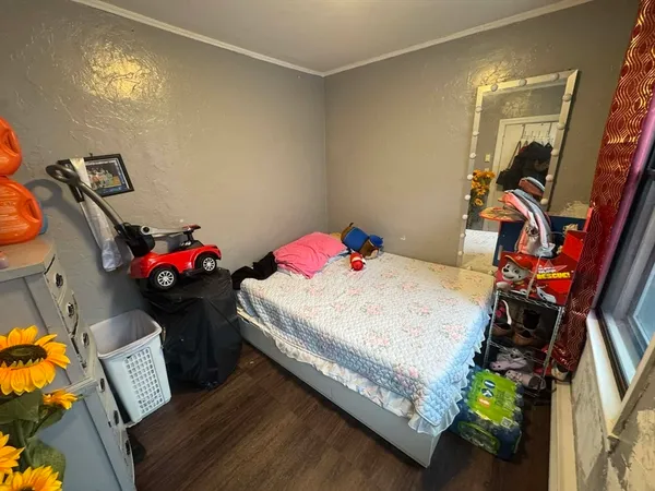 a bedroom with a bed and a tv on the dresser