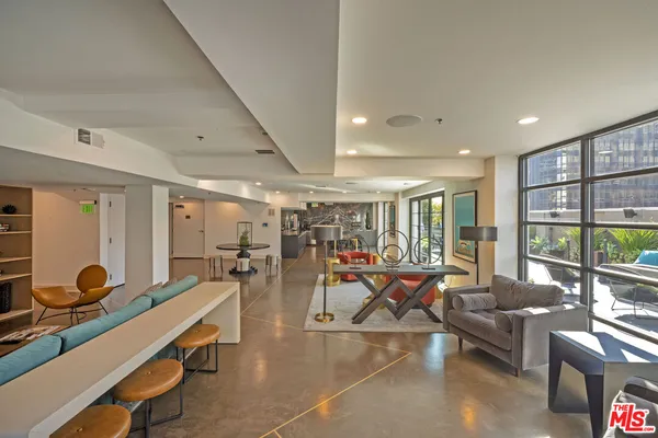 a living room with lots of furniture and windows