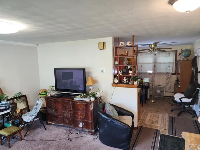 a room with furniture a flat screen computer and a lamp