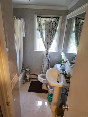 a bathroom with a sink toilet and a mirror