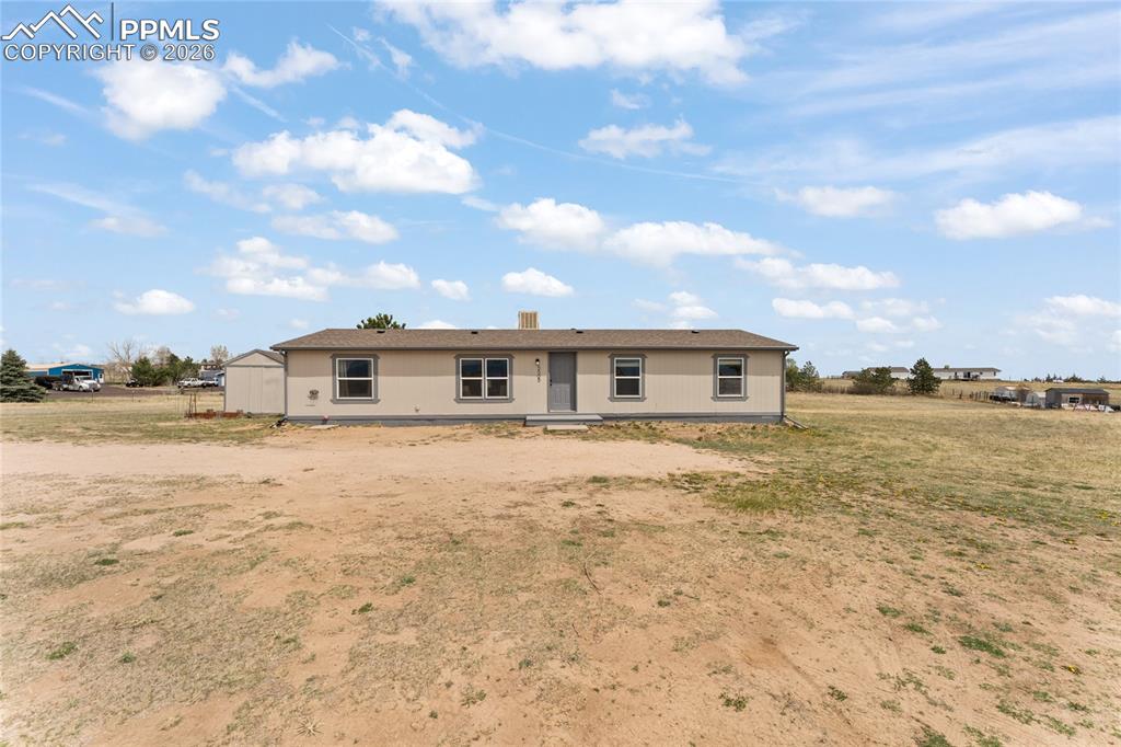 5505 Whipshaw Road Peyton, CO 80831 - Photo 1 of 39 a front view of a house with a yard