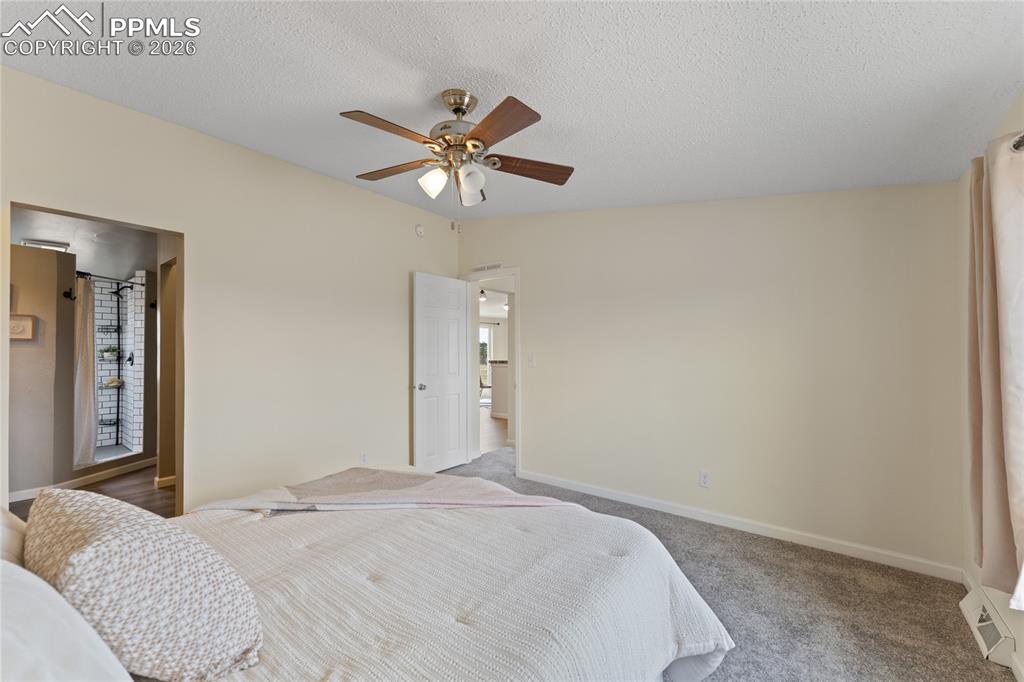 5505 Whipshaw Road Peyton, CO 80831 - Photo 18 of 39 a bedroom with a bed and a chandelier