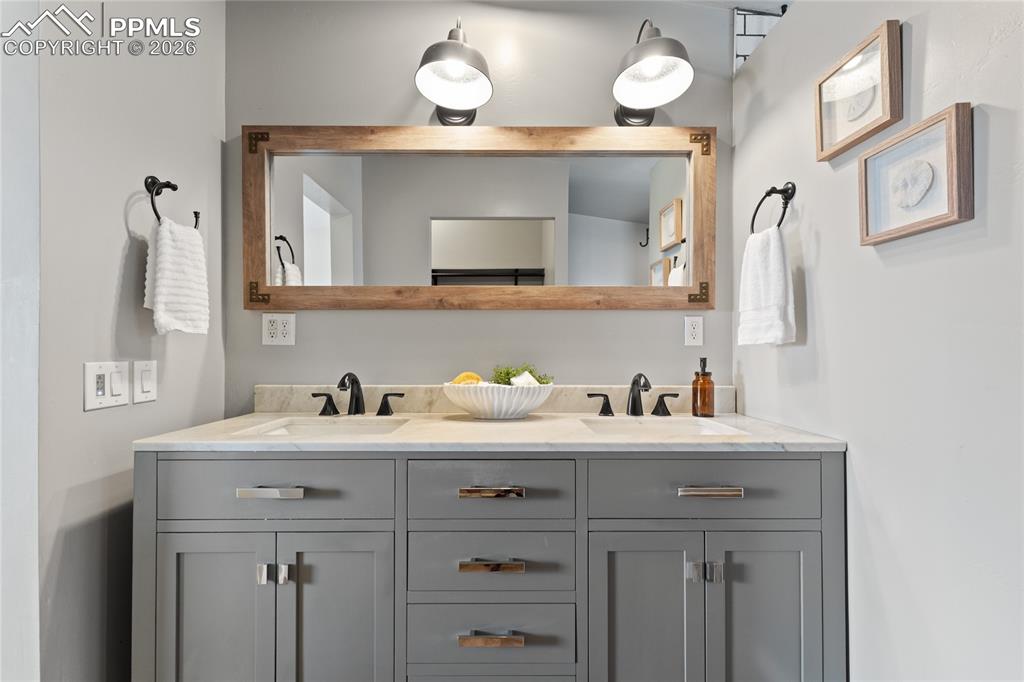 5505 Whipshaw Road Peyton, CO 80831 - Photo 20 of 39 a bathroom with a sink and a mirror