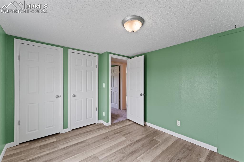 5505 Whipshaw Road Peyton, CO 80831 - Photo 29 of 39 a view of empty room with wooden floor and fan