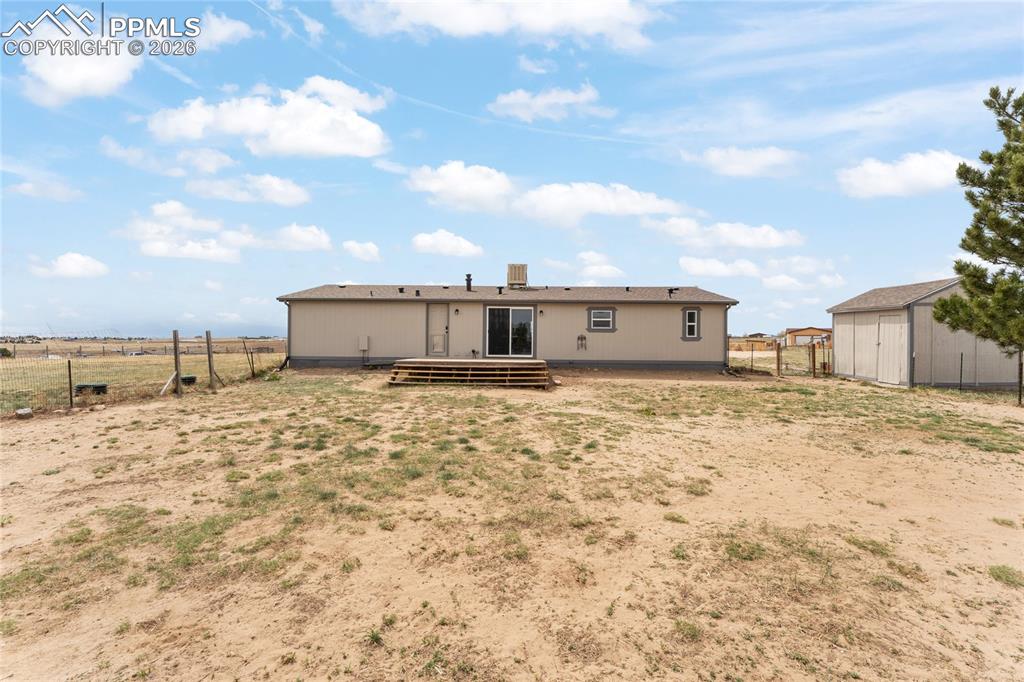 5505 Whipshaw Road Peyton, CO 80831 - Photo 35 of 39 a view of a wooden house with a yard