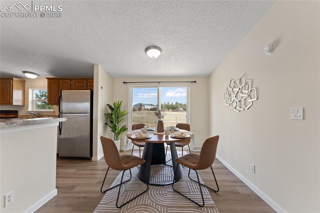 5505 Whipshaw Road Peyton, CO 80831 - Photo 9 of 39 a dining room with furniture and a floor to ceiling window