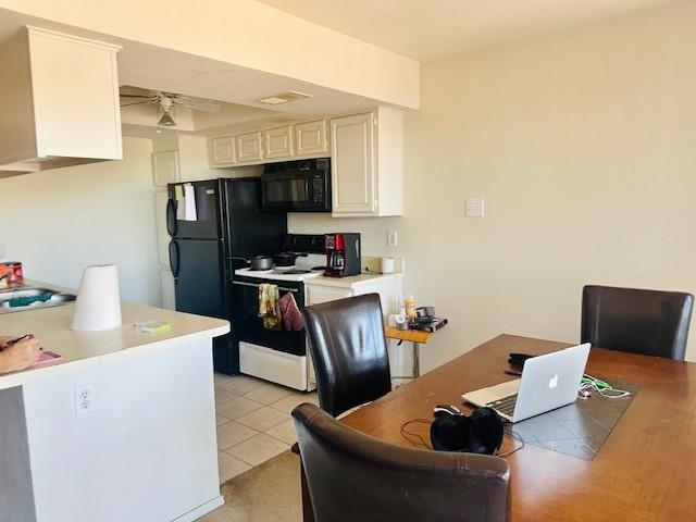 4448 Chaha Road, Unit 205 Garland, TX 75043 - Photo 2 of 5 Kitchen featuring white cabinetry, black appliances, a ceiling fan, and tile flooring