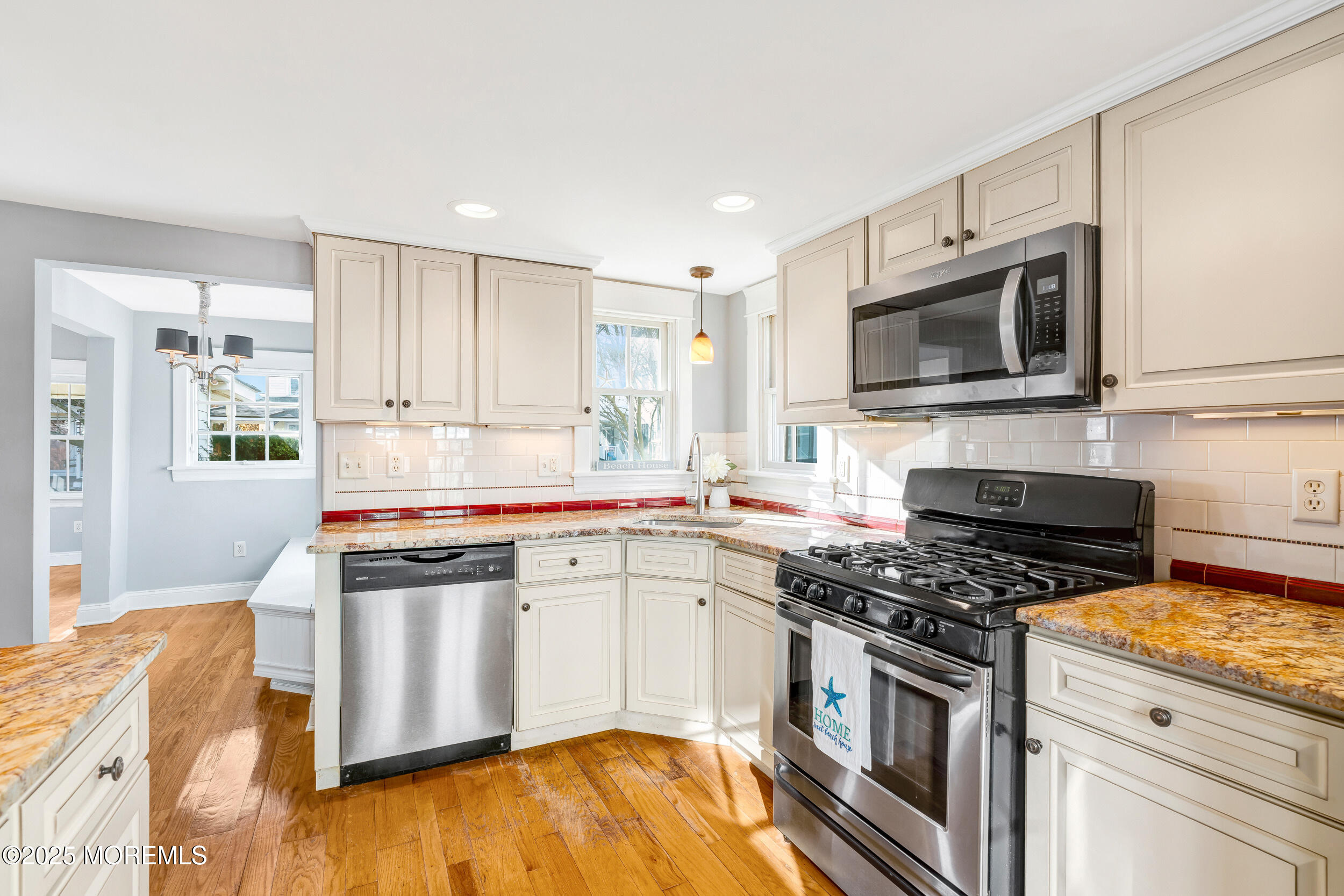 81 Inskip Avenue Ocean Grove, NJ 07756 - Photo 22 of 86 a kitchen with stainless steel appliances a stove a microwave and cabinets
