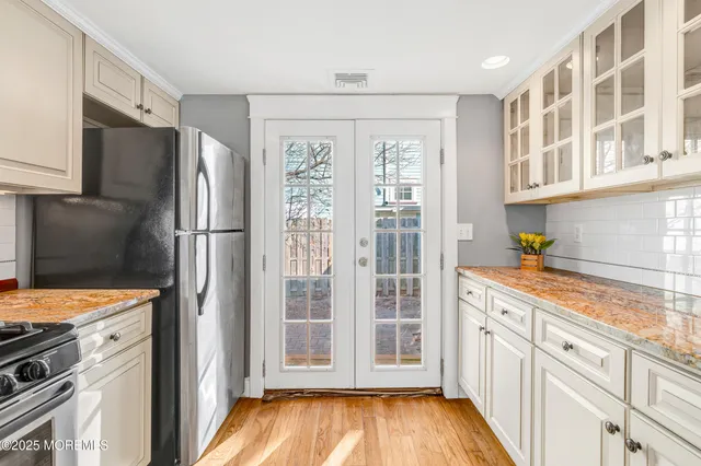 a view of a bedroom with wooden floor and a bathroom