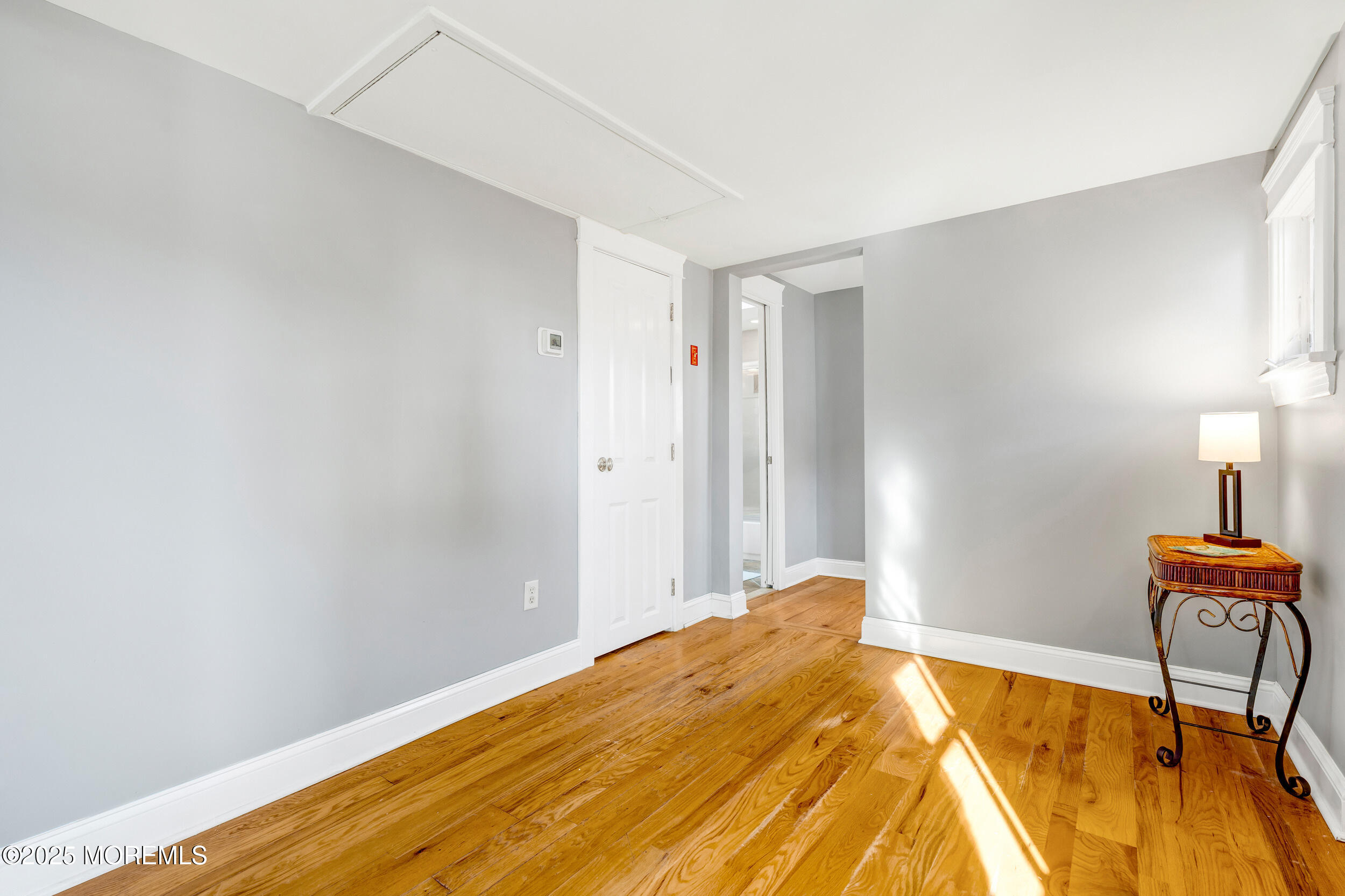 81 Inskip Avenue Ocean Grove, NJ 07756 - Photo 34 of 86 a bedroom with a bed and a lamp on table