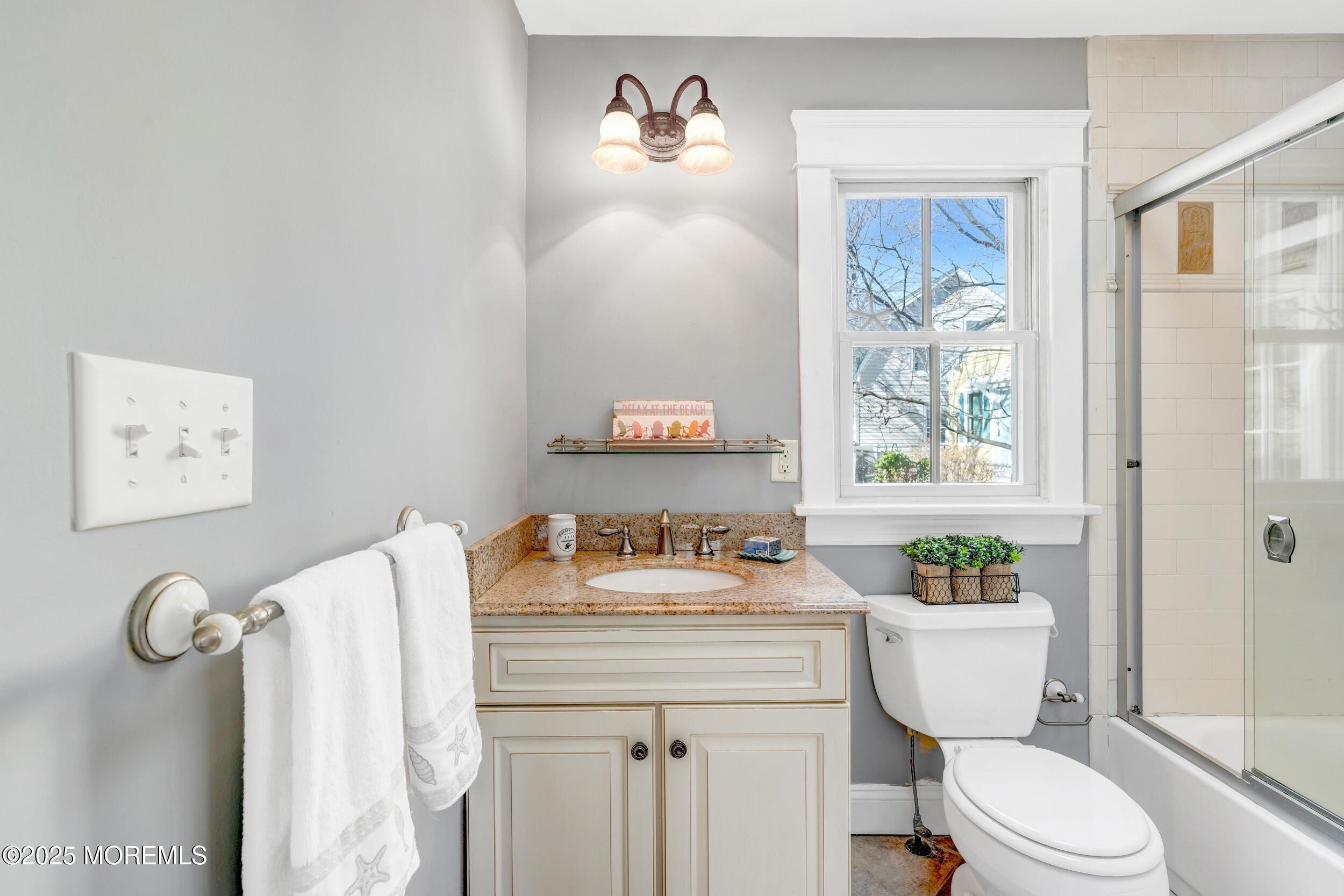 81 Inskip Avenue Ocean Grove, NJ 07756 - Photo 40 of 86 a bathroom with a granite countertop toilet a sink and a window