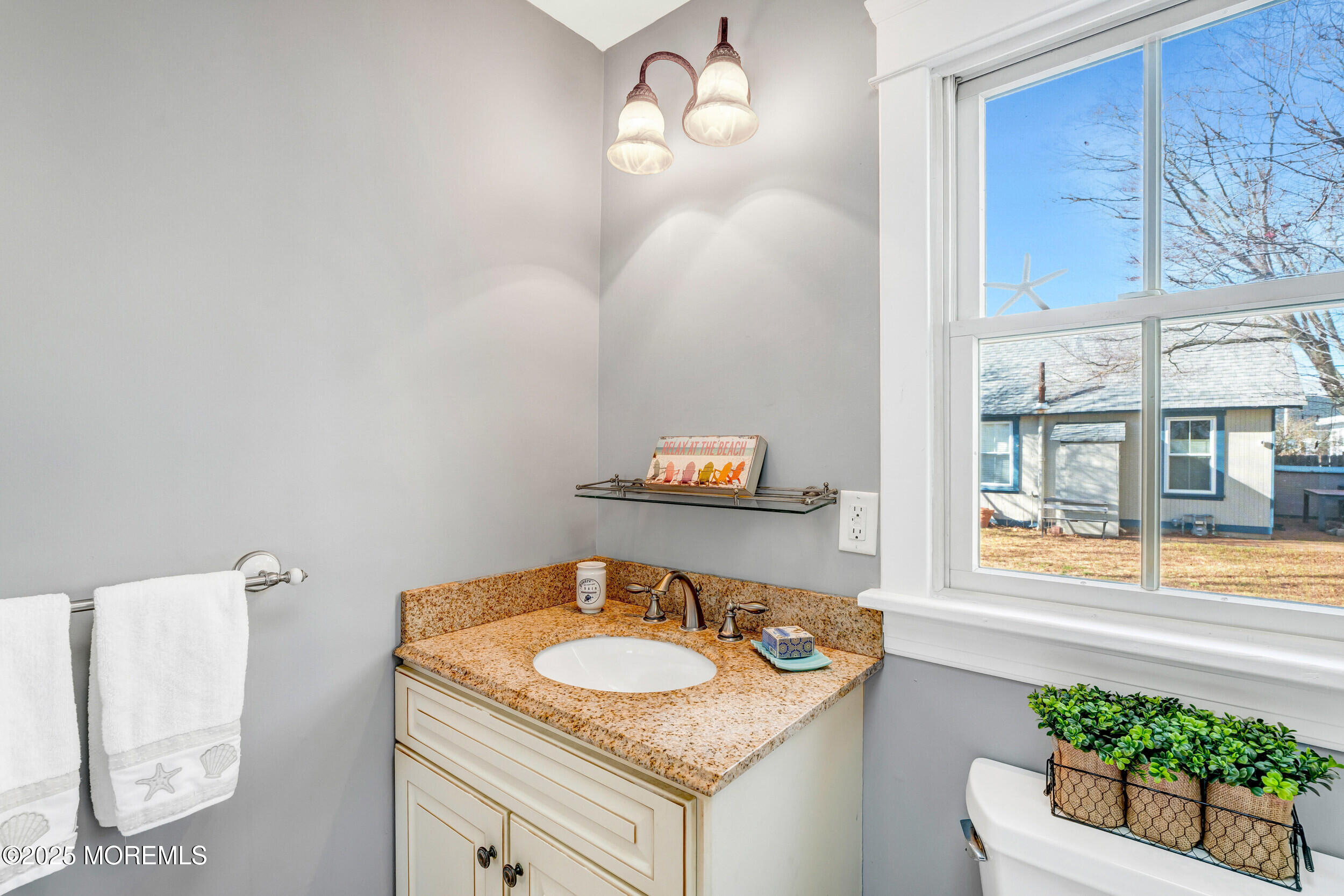 81 Inskip Avenue Ocean Grove, NJ 07756 - Photo 44 of 86 a bathroom with a granite countertop sink and a mirror