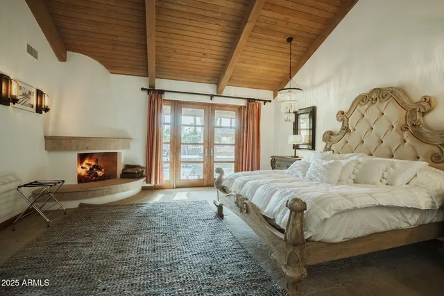 a spacious bedroom with a bed and a fireplace