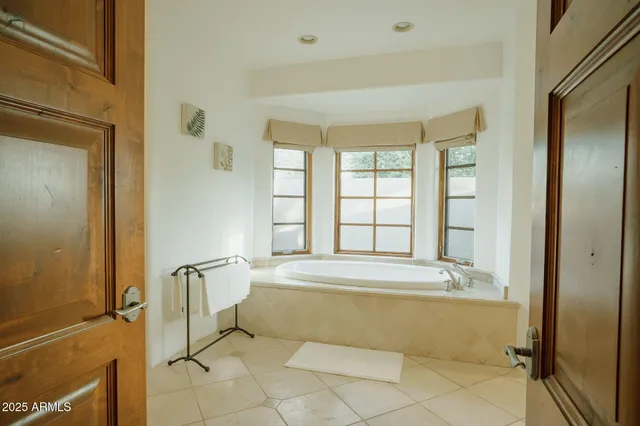 a spacious bathroom with a tub and shower