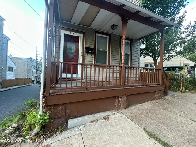 a view of a chair and tables in the balcony