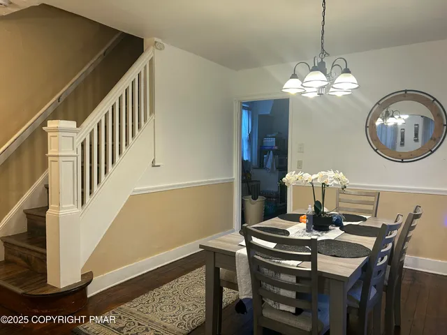 a view of a dining room with furniture and a chandelier