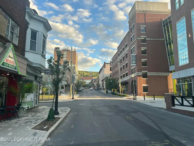 a view of a street with a building in the background