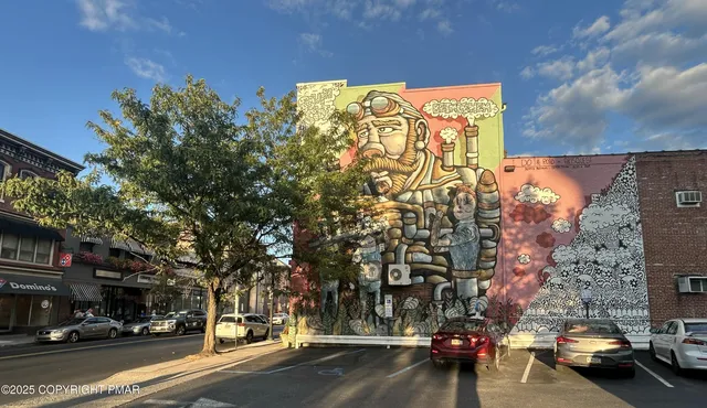 a city street lined with buildings and cars