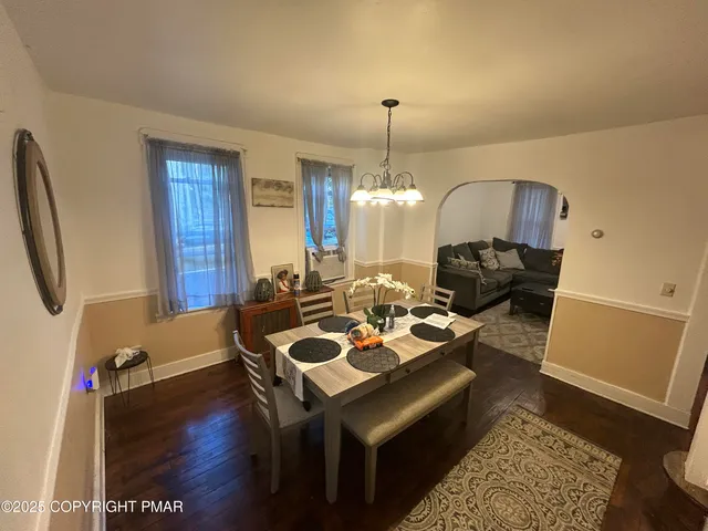 a view of a workspace with furniture and wooden floor
