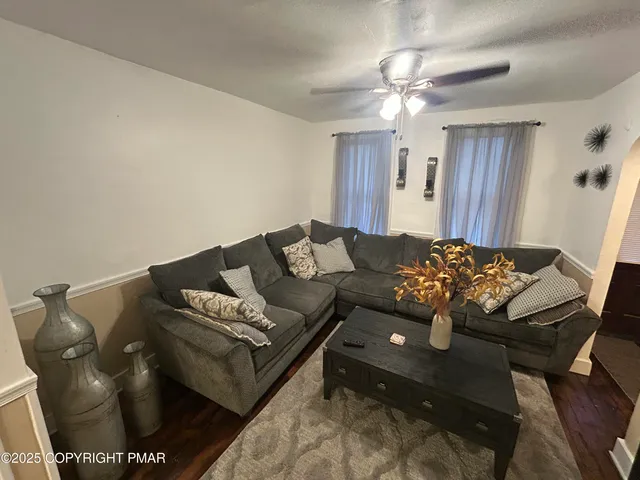 a living room with furniture and a chandelier