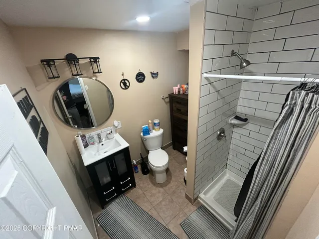 a bathroom with a toilet sink and mirror