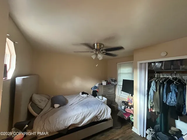 a bedroom with a bed and a television