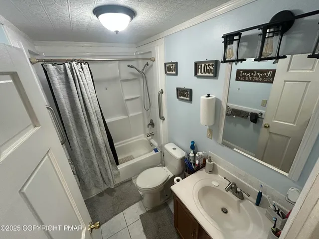 a bathroom with a sink and mirror with toilet