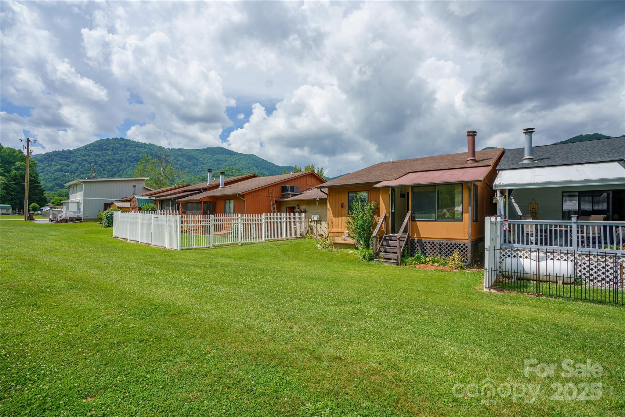 94 Market Street Maggie Valley, NC 28751 - Photo 1 of 40 a view of a house with a yard porch and sitting area