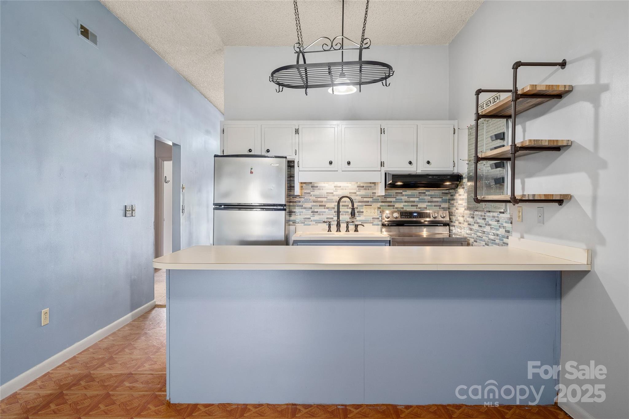 94 Market Street Maggie Valley, NC 28751 - Photo 15 of 40 a kitchen with stainless steel appliances granite countertop a sink a stove and white cabinets