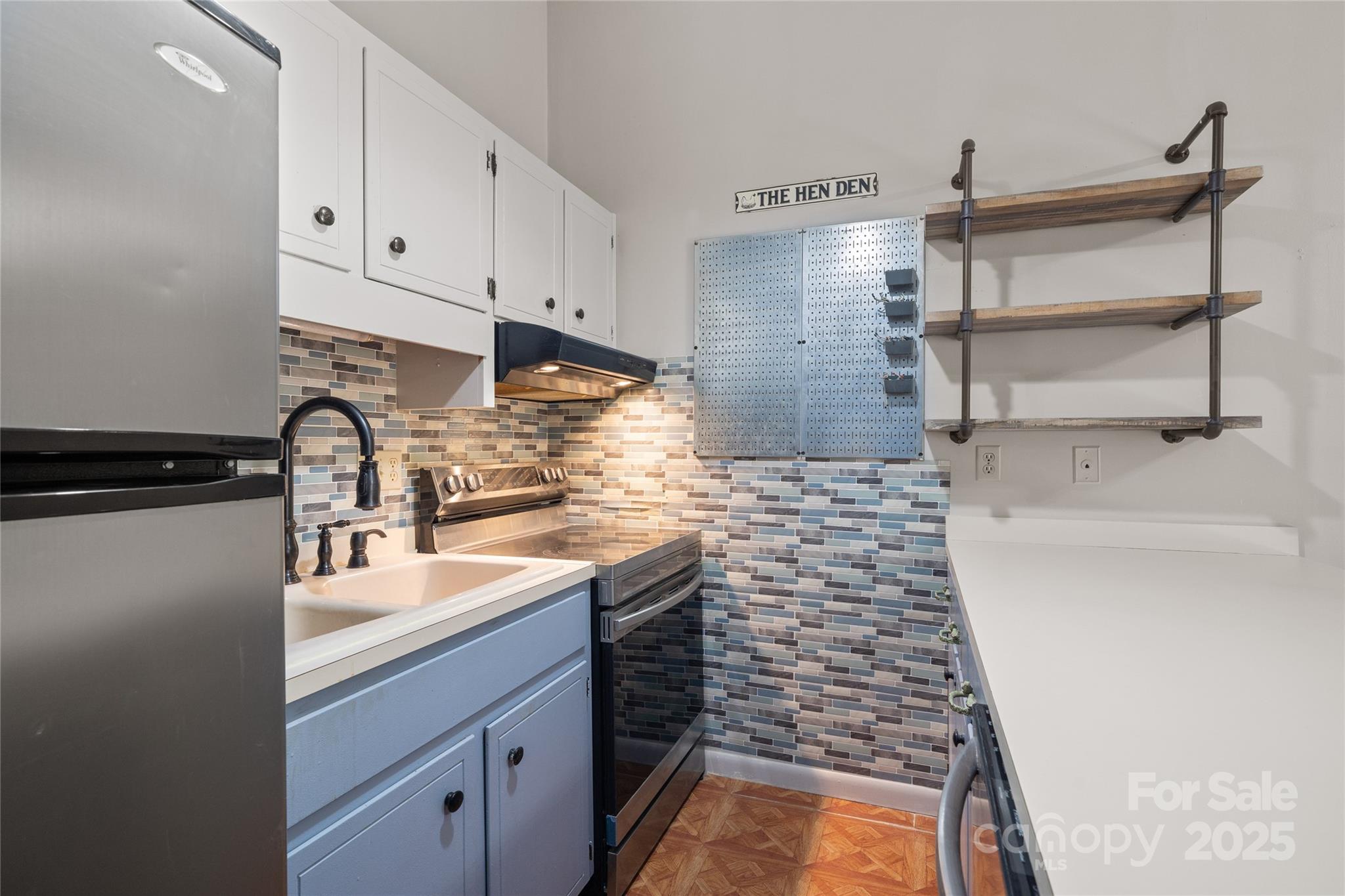 94 Market Street Maggie Valley, NC 28751 - Photo 16 of 40 a kitchen with a sink and cabinets